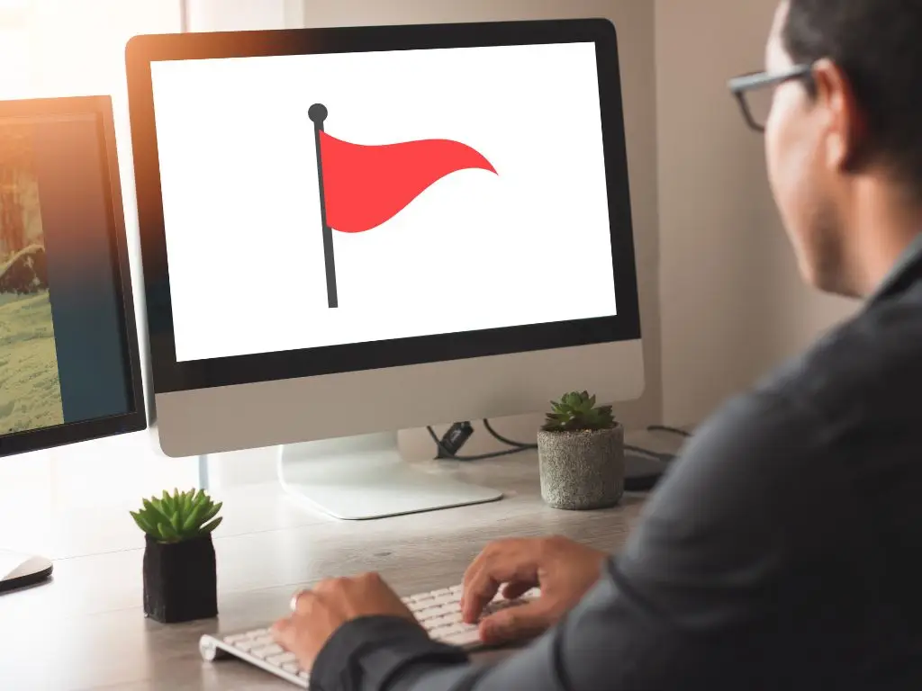 A red flag shows on a computer screen